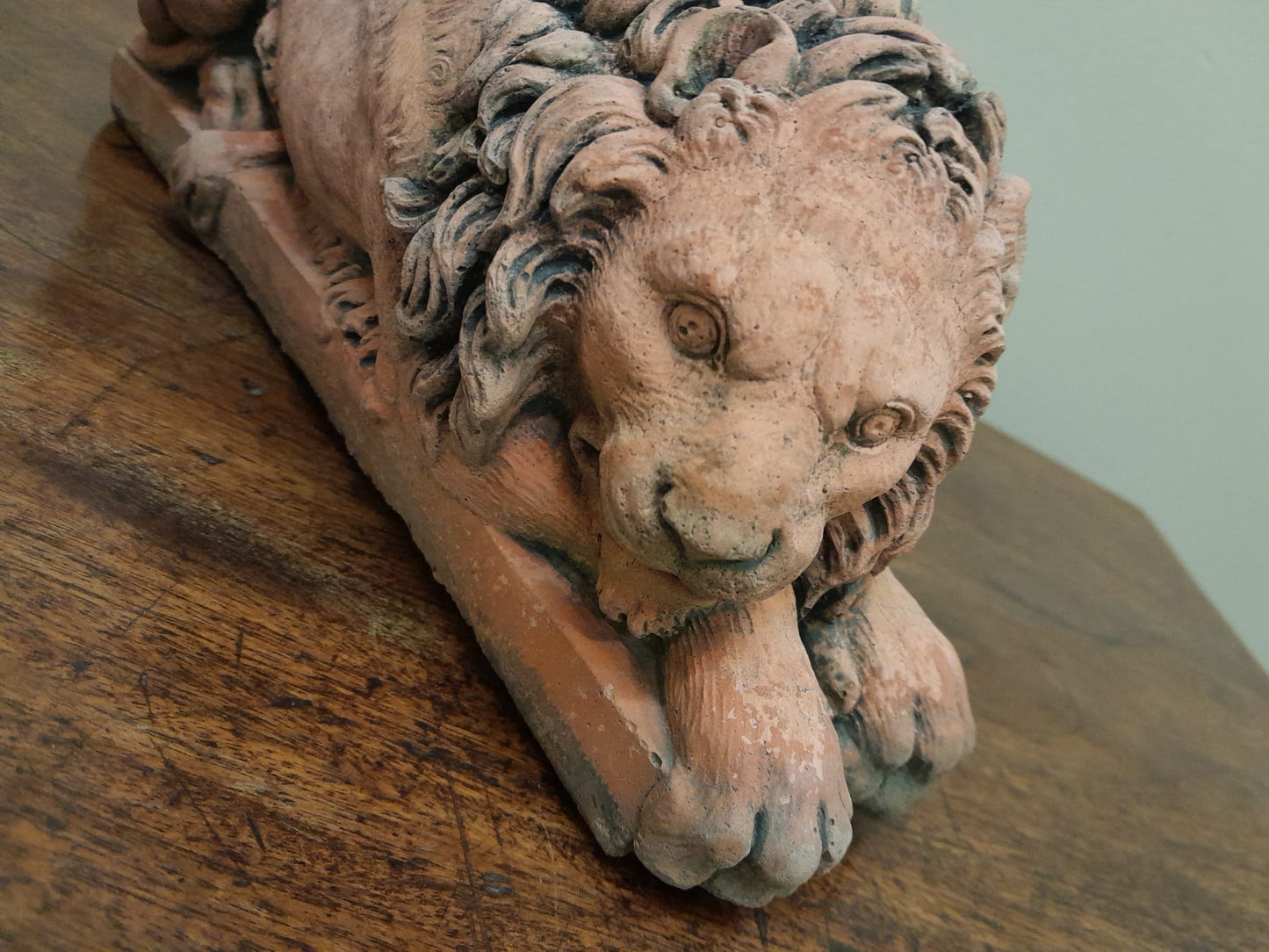 A pair of vintage recumbent terracotta lions