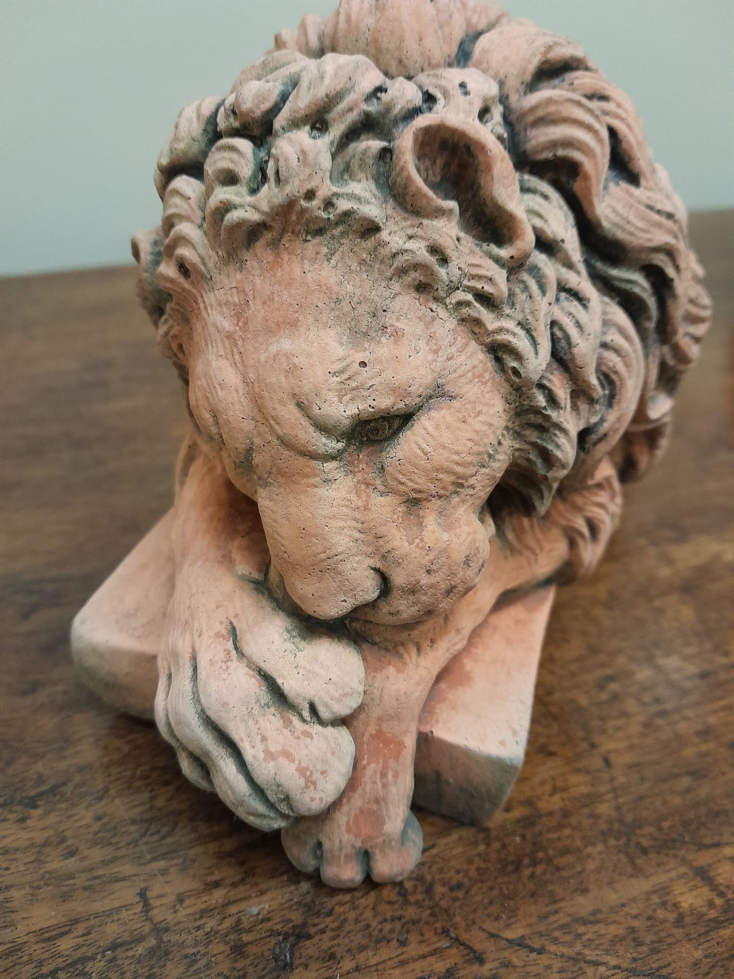 A pair of vintage recumbent terracotta lions