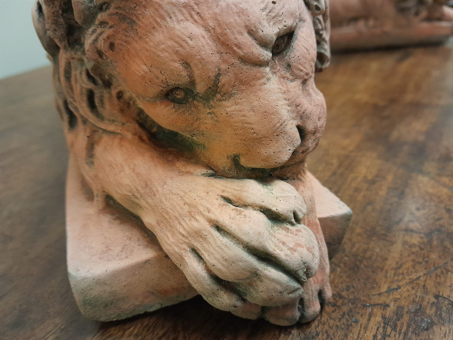 A pair of vintage recumbent terracotta lions