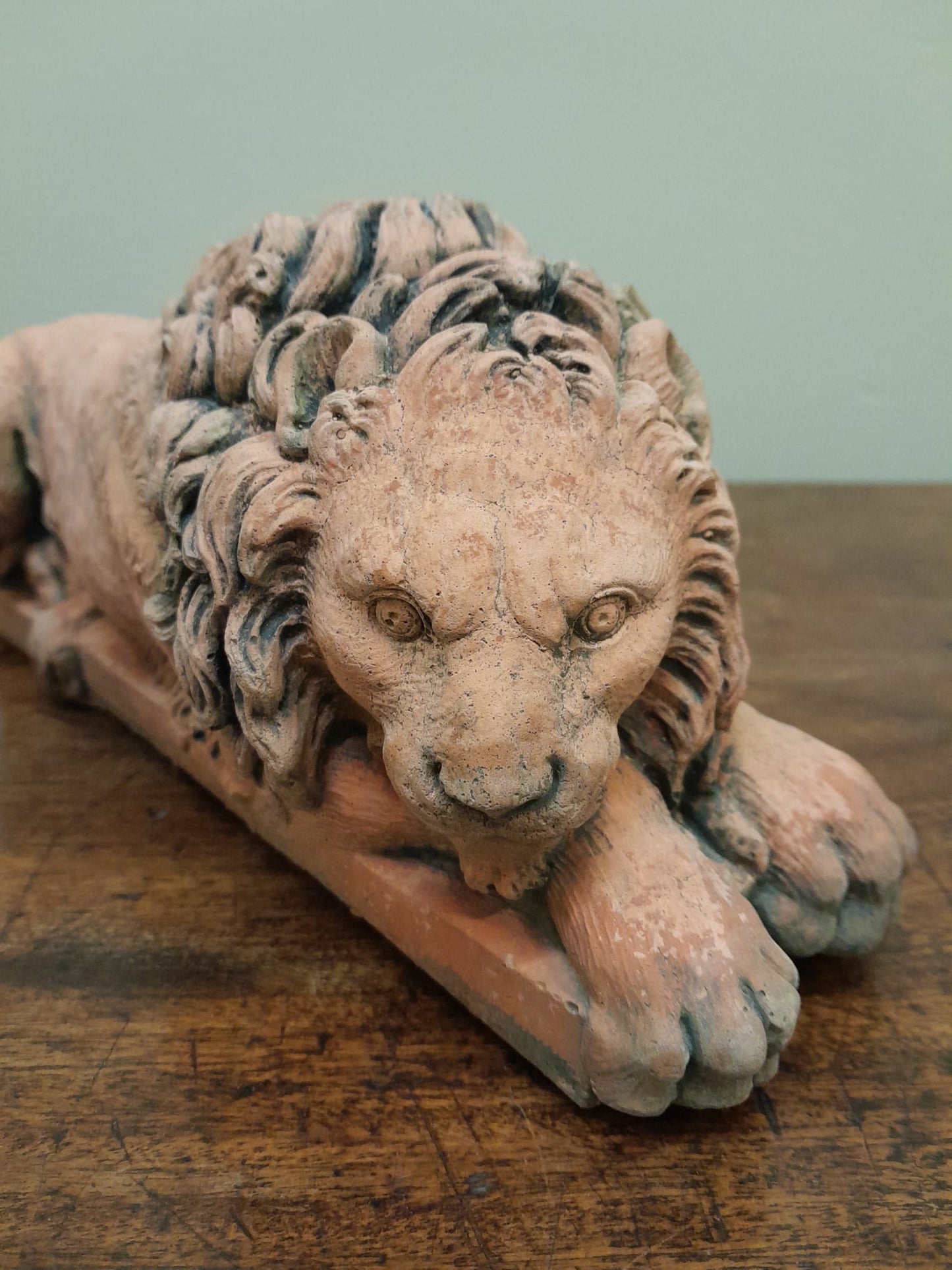 A pair of vintage recumbent terracotta lions