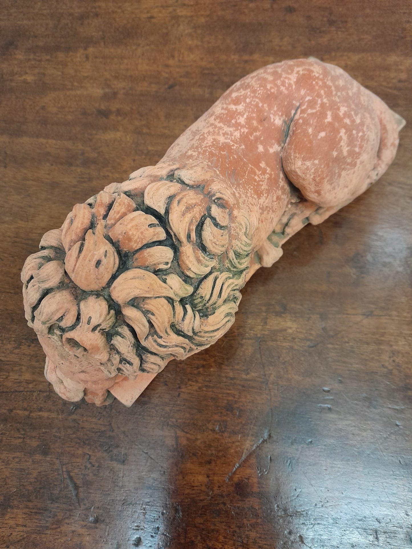 A pair of vintage recumbent terracotta lions